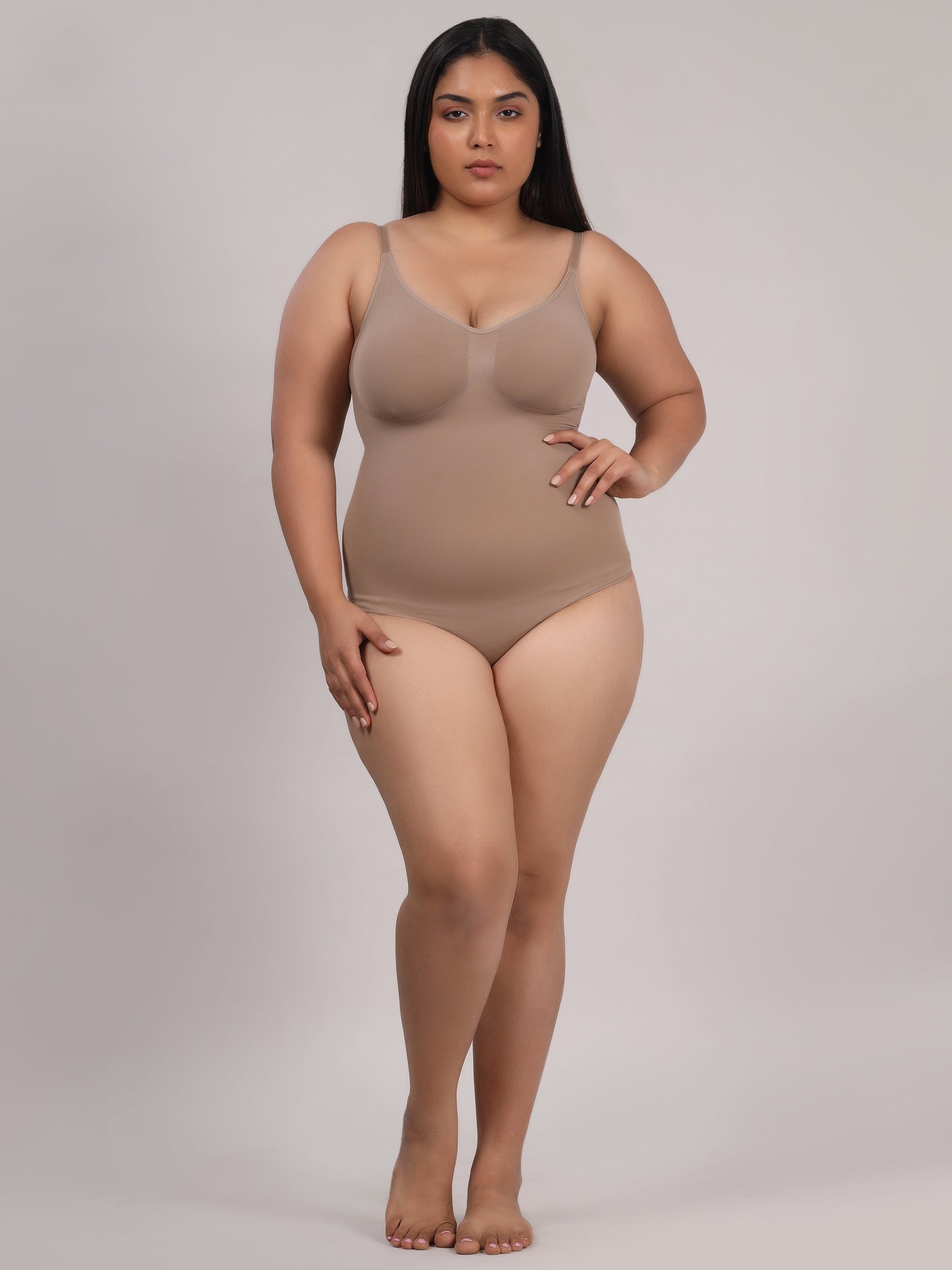 Beige seamless tummy control bodysuit side profile showing smooth silhouette