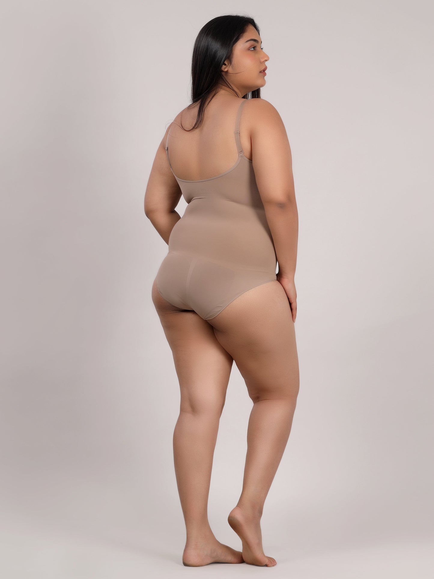 Beige seamless body shaper bodysuit back view with adjustable straps